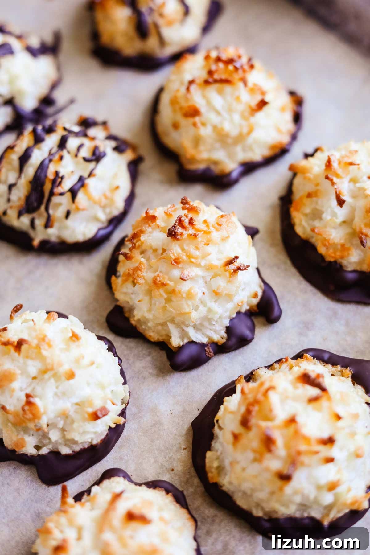 Chewy Coconut Macaroons: Gluten-Free Coconut Cookie Recipe 2 Gluten-free coconut macaroons drizzled and dipped in chocolate on a sheet pan.