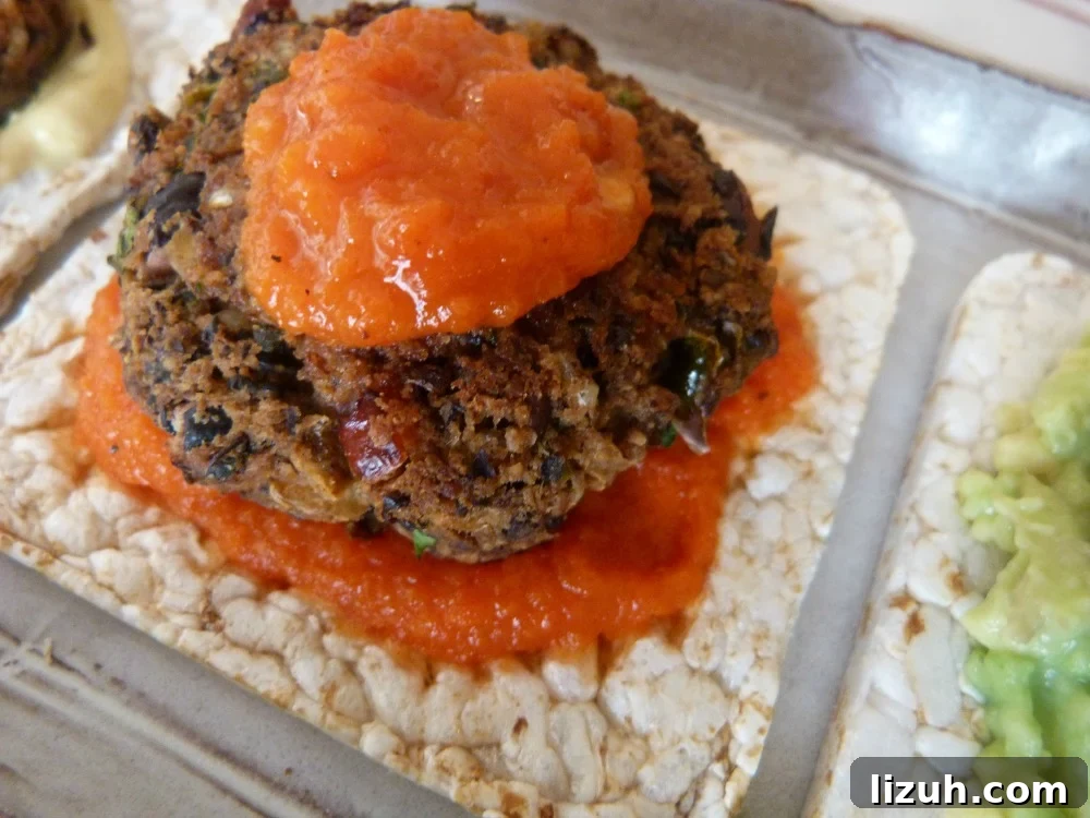 Black Bean Veggie Burger Recipe — Flavorful Homemade Patties 13 Red pepper sauce underneath and on top of a mini black bean veggie burger.