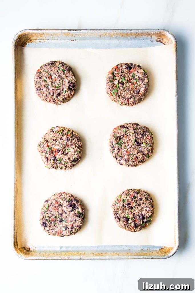 Black Bean Veggie Burger Recipe — Flavorful Homemade Patties 9 6 black bean burgers on a parchment lined baking tray