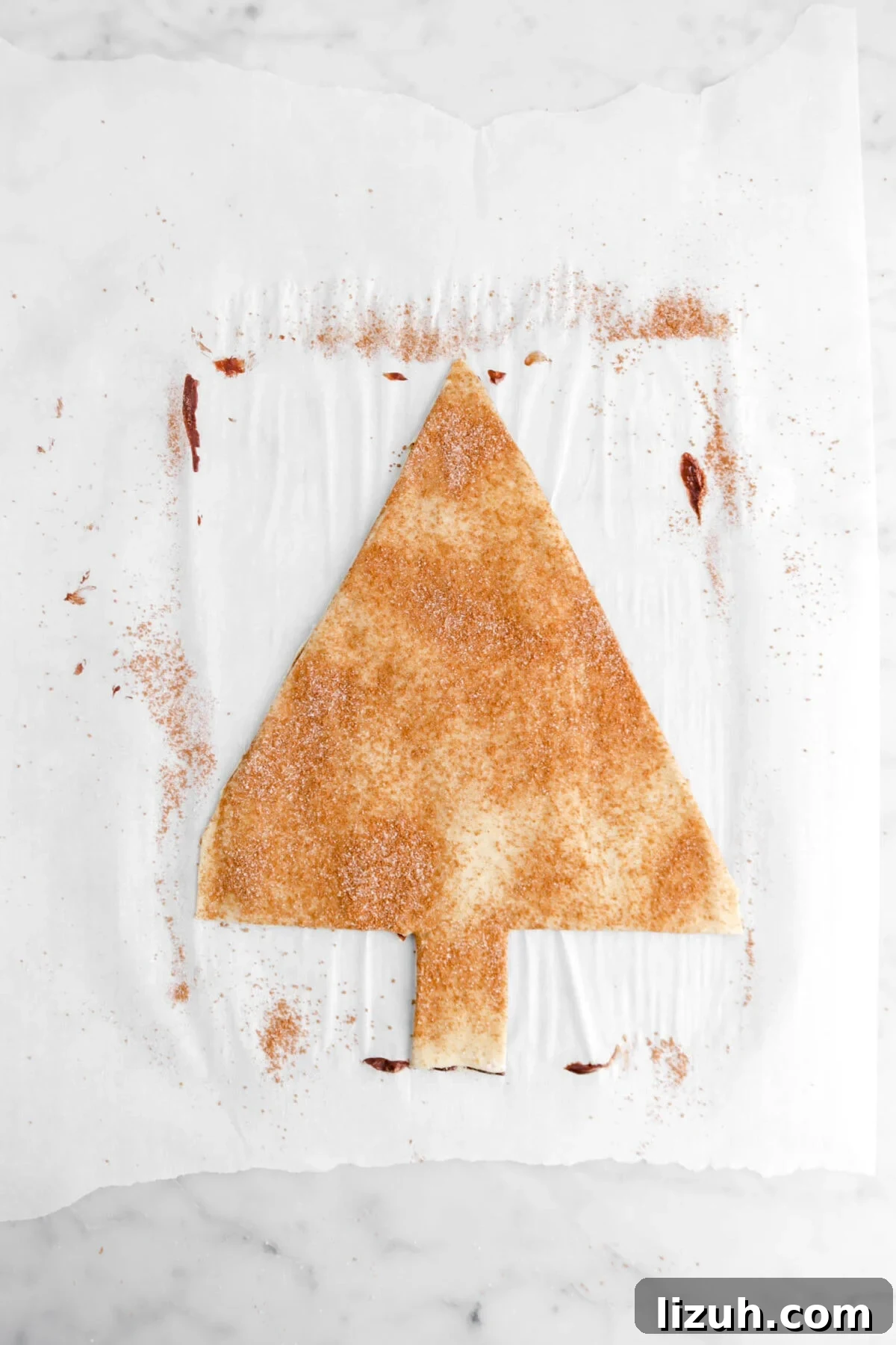christmas tree shaped puff pastry on parchment paper.
