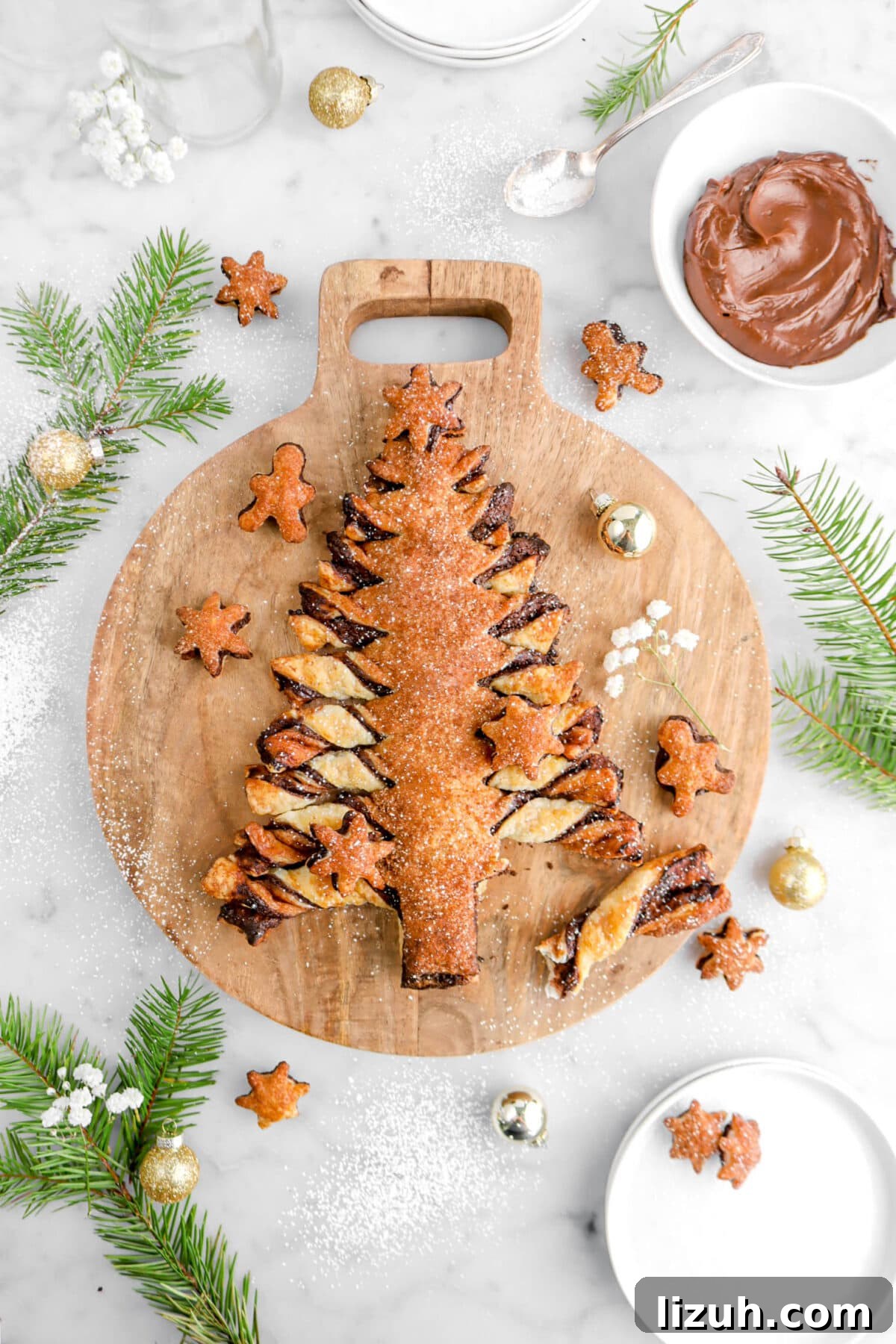 overhead shot of christmas tree shaped tear and share with one piece pulled away on wood board.