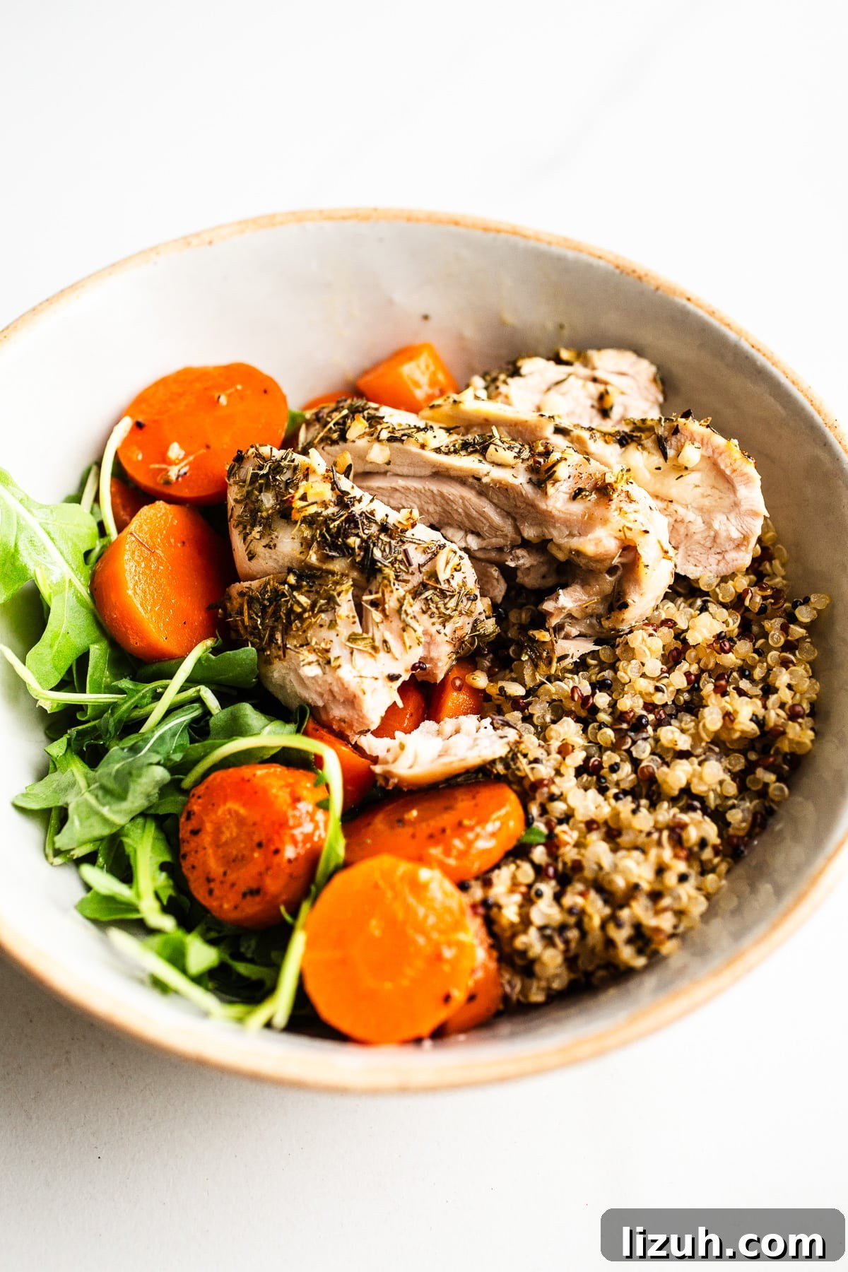 Roasted Carrot and Chicken Quinoa Bowl with Lemon-Tahini Drizzle 8 Chicken, carrots, and quinoa in a bowl.