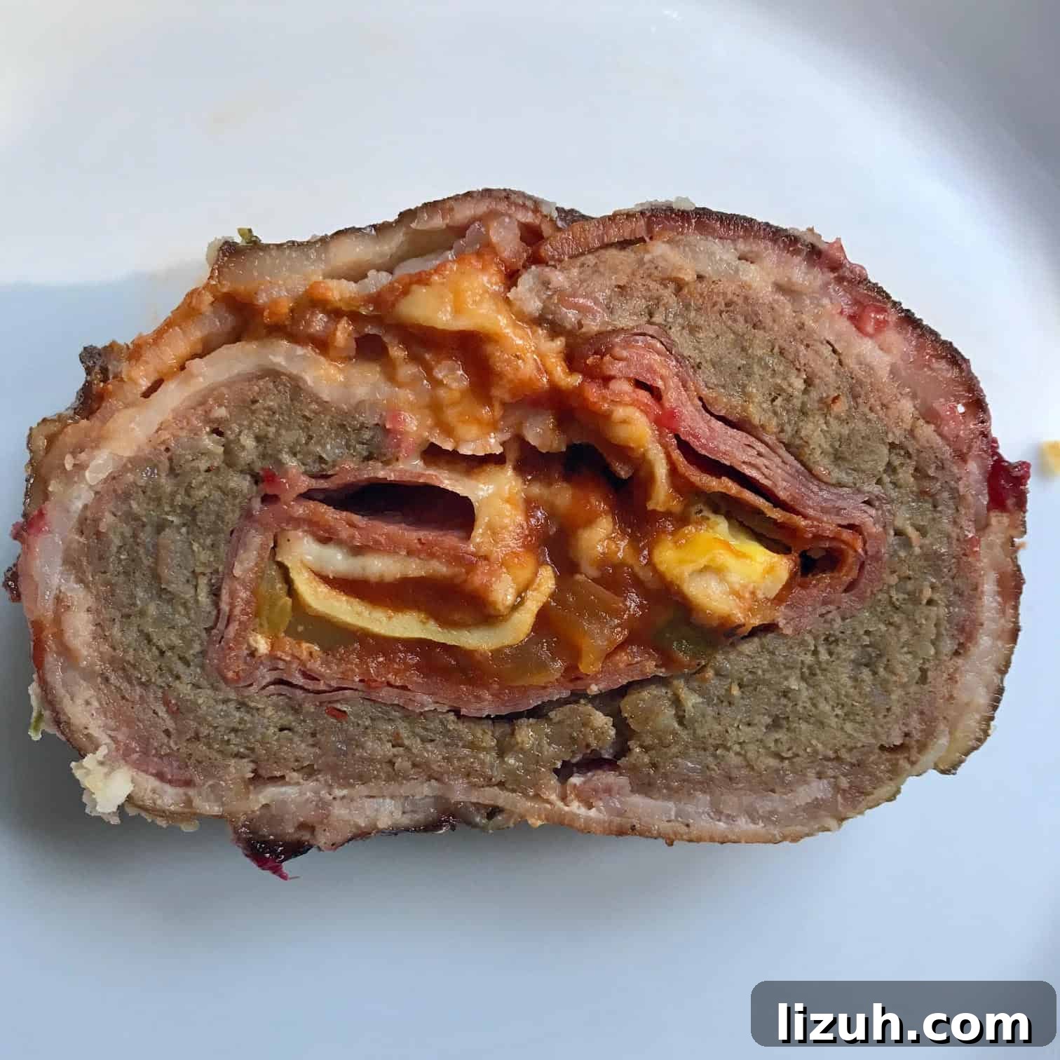Bacon Explosion Pizza: Stuffed Crust Pizza Fatty Recipe 2 Pizza Bacon Explosion slice on white background overhead shot