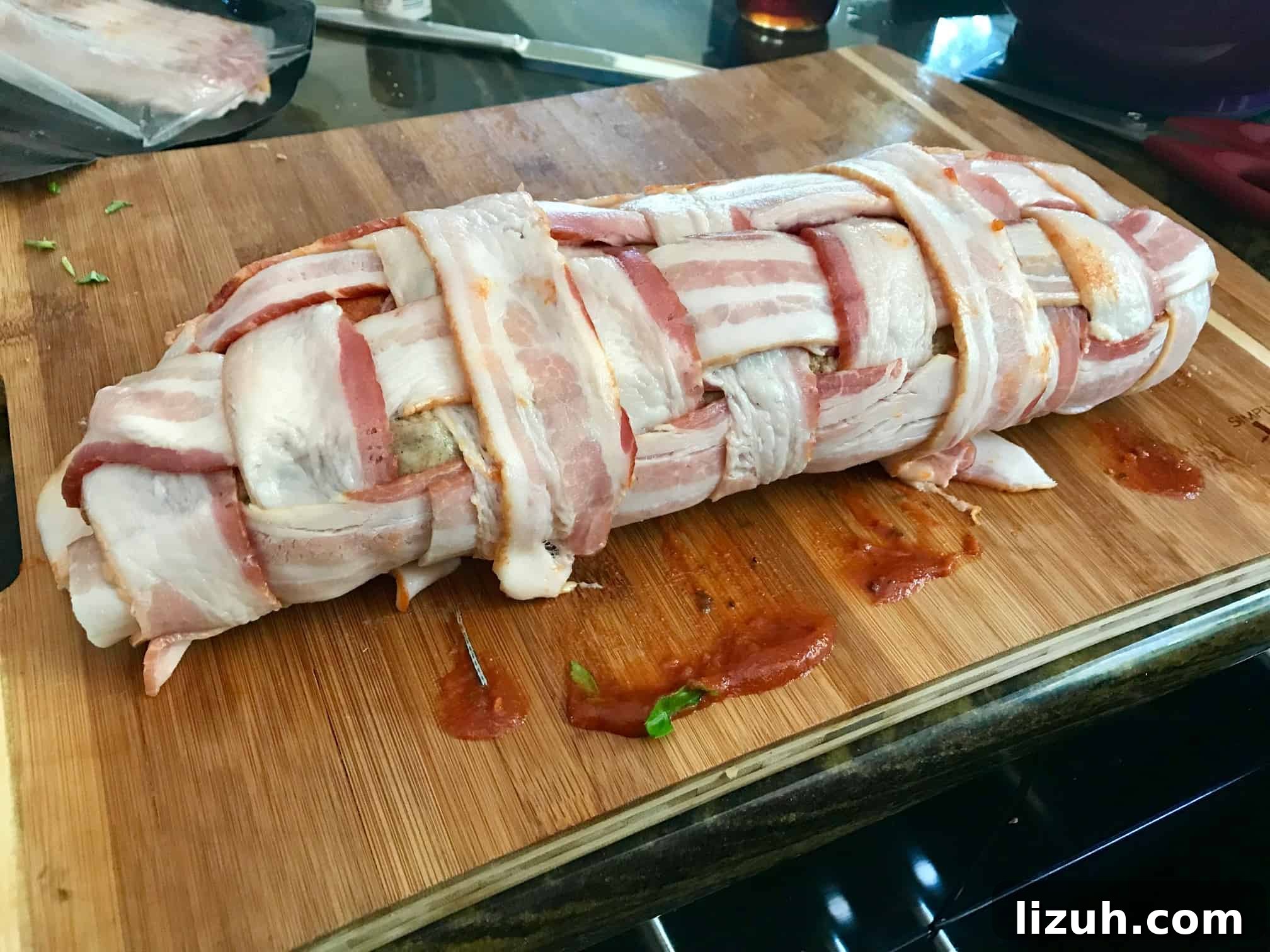 Bacon Explosion Pizza: Stuffed Crust Pizza Fatty Recipe 6 Pizza Bacon Explosion rolled up on wooden cutting board side view