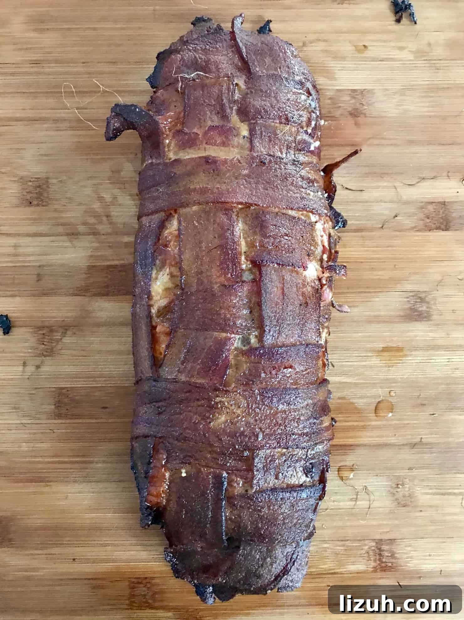 Bacon Explosion Pizza: Stuffed Crust Pizza Fatty Recipe 8 Pizza Bacon Explosion smoked sitting on wooden cutting board overhead shot