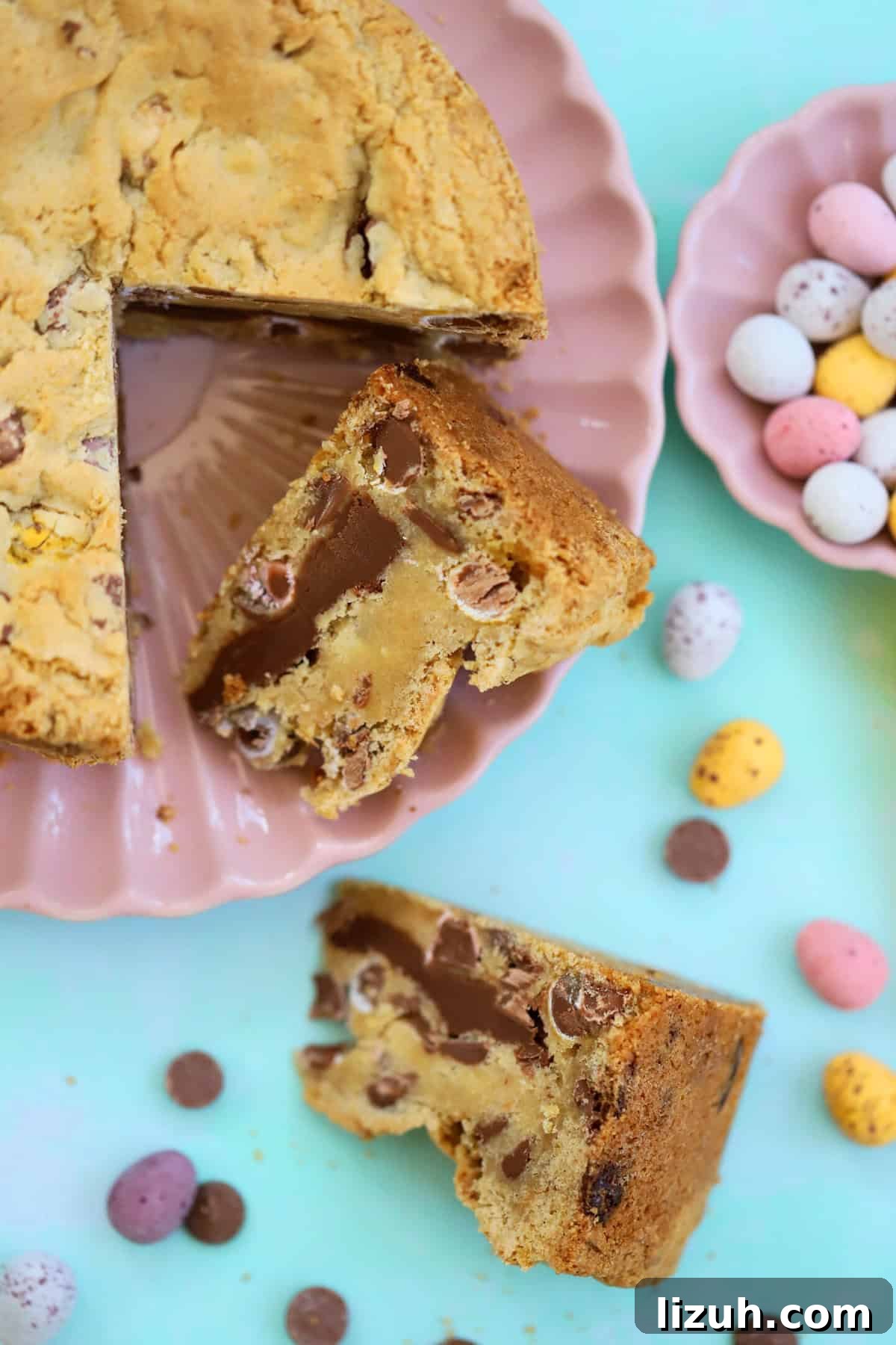 Mini Egg Cookie Pie Recipe: Creamy No-Bake Easter Dessert 9 A Mini Egg Cookie Pie with a wedge taken out of it, on a pink plate.