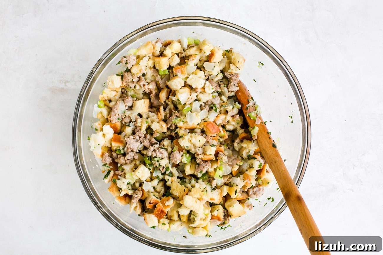 Sausage Stuffing Recipe with Herbs and Crispy Bread 8 all the ingredients mixed in a glass bowl