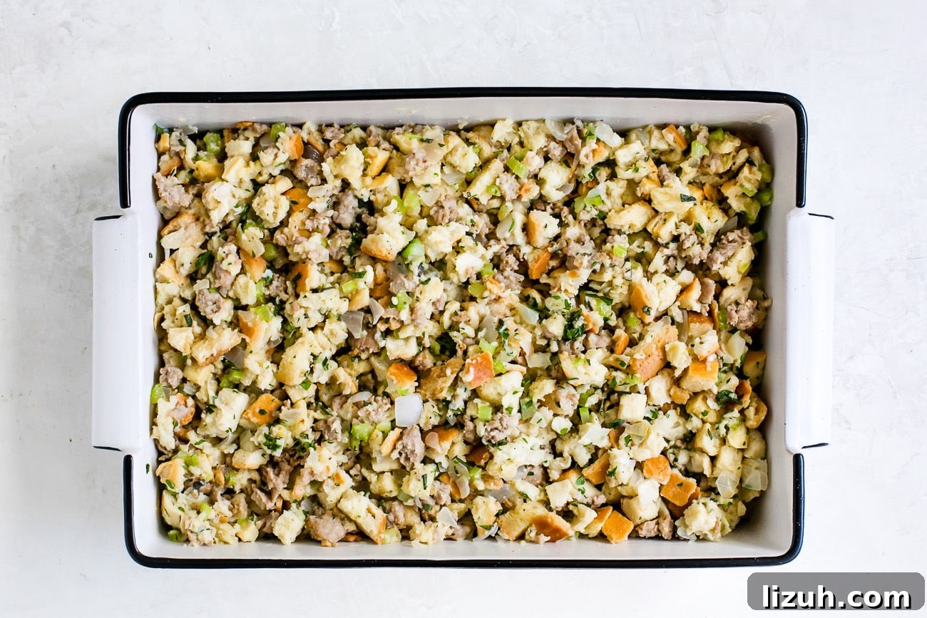 Sausage Stuffing Recipe with Herbs and Crispy Bread 9 stuffing in a white casserole