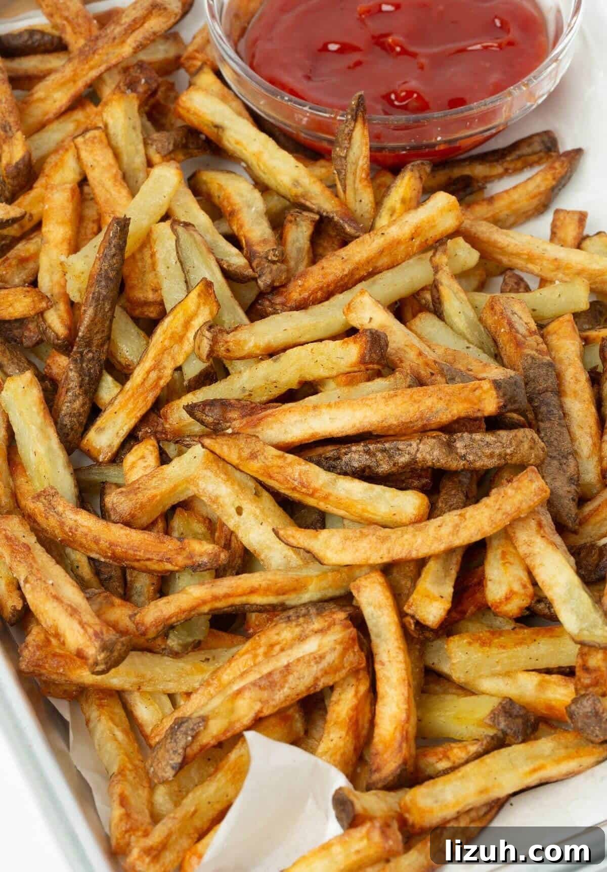 Crispy Air Fryer French Fries: Perfect Golden Recipe 11 tray of air fryer french fries with small bowl of ketchup
