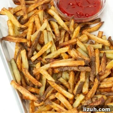 Crispy Air Fryer French Fries: Perfect Golden Recipe 16 tray of air fryer french fries with small bowl of ketchup