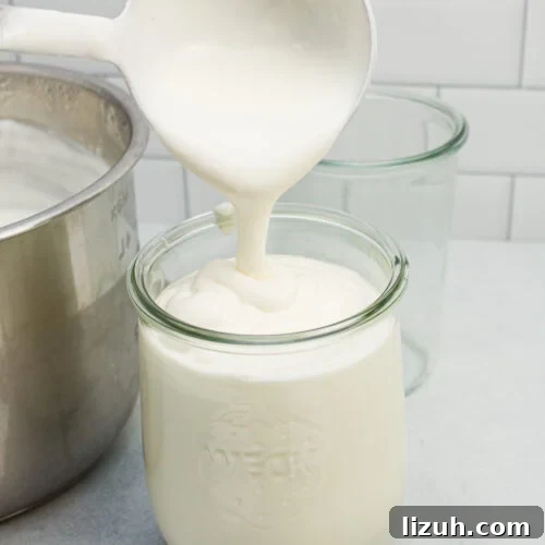 How to Make Creamy Instant Pot Yogurt at Home 21 Ladling homemade yogurt into a glass jar for storage.