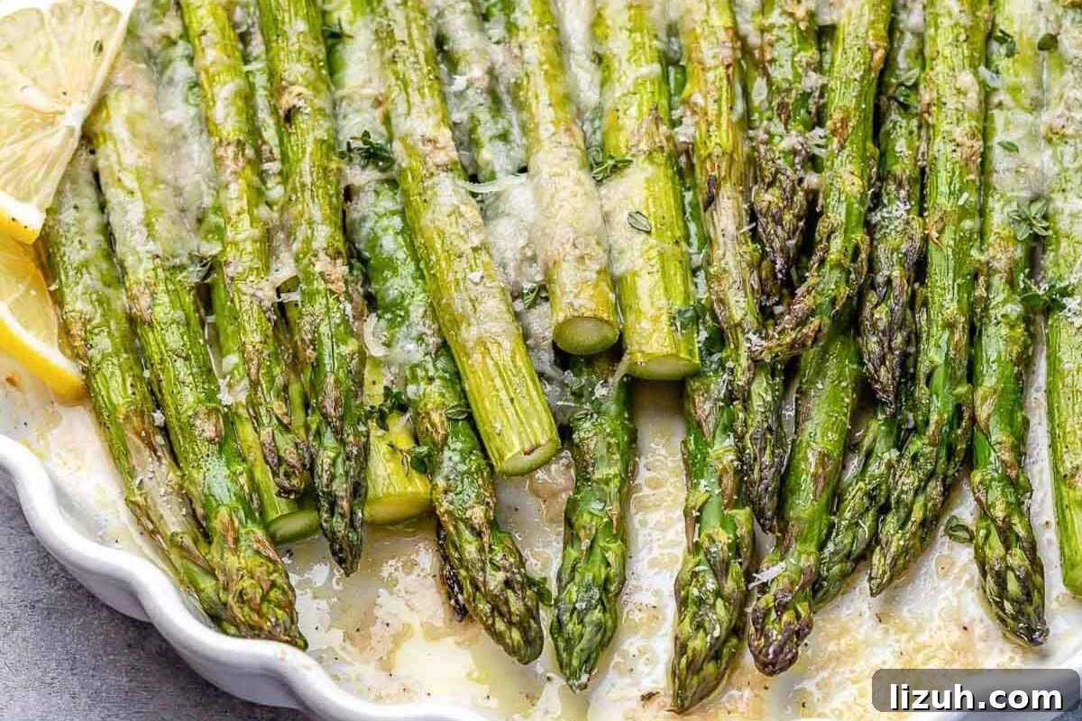 Crispy Parmesan-Roasted Asparagus — Oven-Baked Recipe 5 baked asparagus with parmesan cheese and lemon garnish.