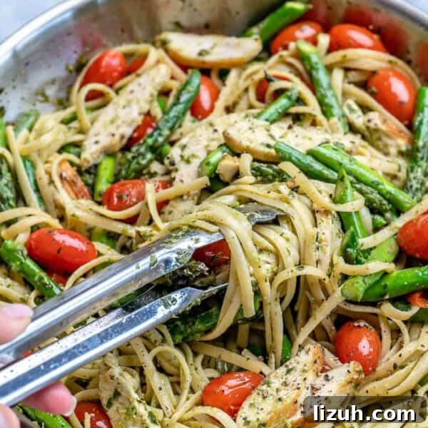 Crispy Parmesan-Roasted Asparagus — Oven-Baked Recipe 8 tong grabbing some chicken asparagus pasta from pan