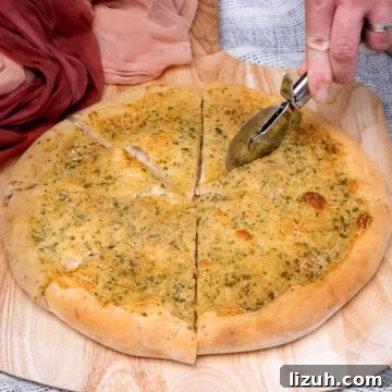 Cutting the Garlic Pizza Bread with a pizza slicer