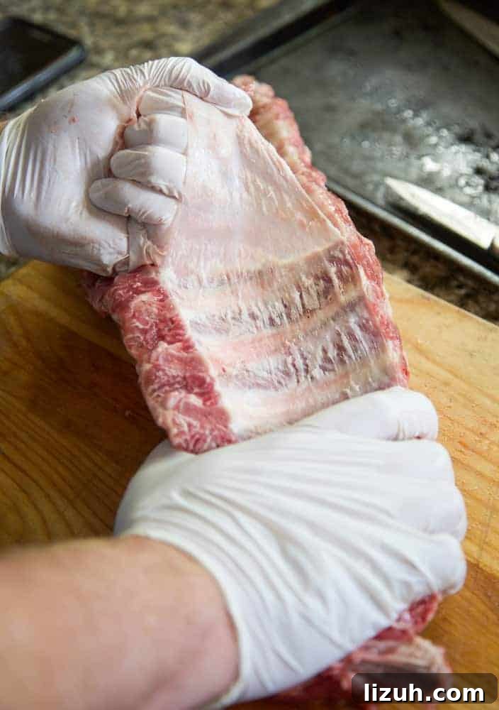 Blueberry Bourbon Glazed Baby Back Ribs Recipe 5 pulling the silver skin from the back of the rib rack
