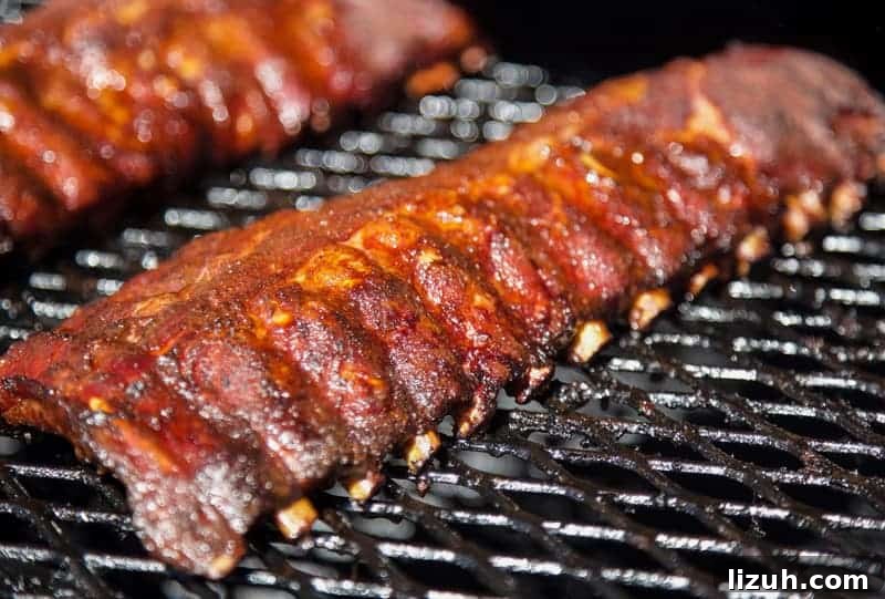 Blueberry Bourbon Glazed Baby Back Ribs Recipe 8 Bones retracting on smoked ribs. 3-2-1 method.