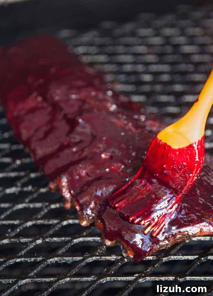 Blueberry Bourbon Glazed Baby Back Ribs Recipe 9 Applying Blueberry Bourbon Rosemary BBQ Sauce to Smoked Ribs