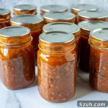 Canning jars filled with chili with beans.