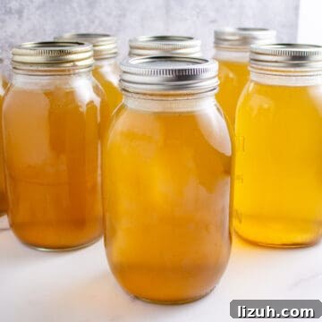 Canning jars filled with chicken stock.