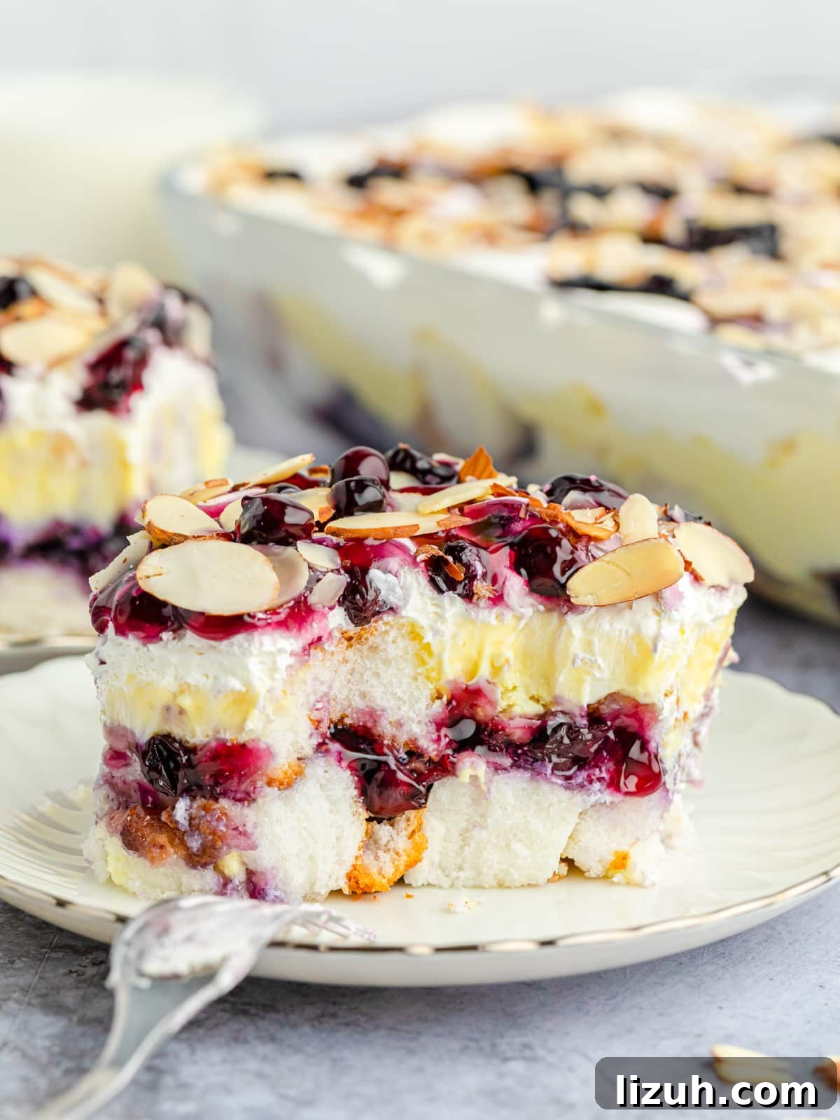 No-Bake Blueberry Angel Food Cake Recipe 9 Blueberry Heaven on Earth cake slice with bites taken on a plate