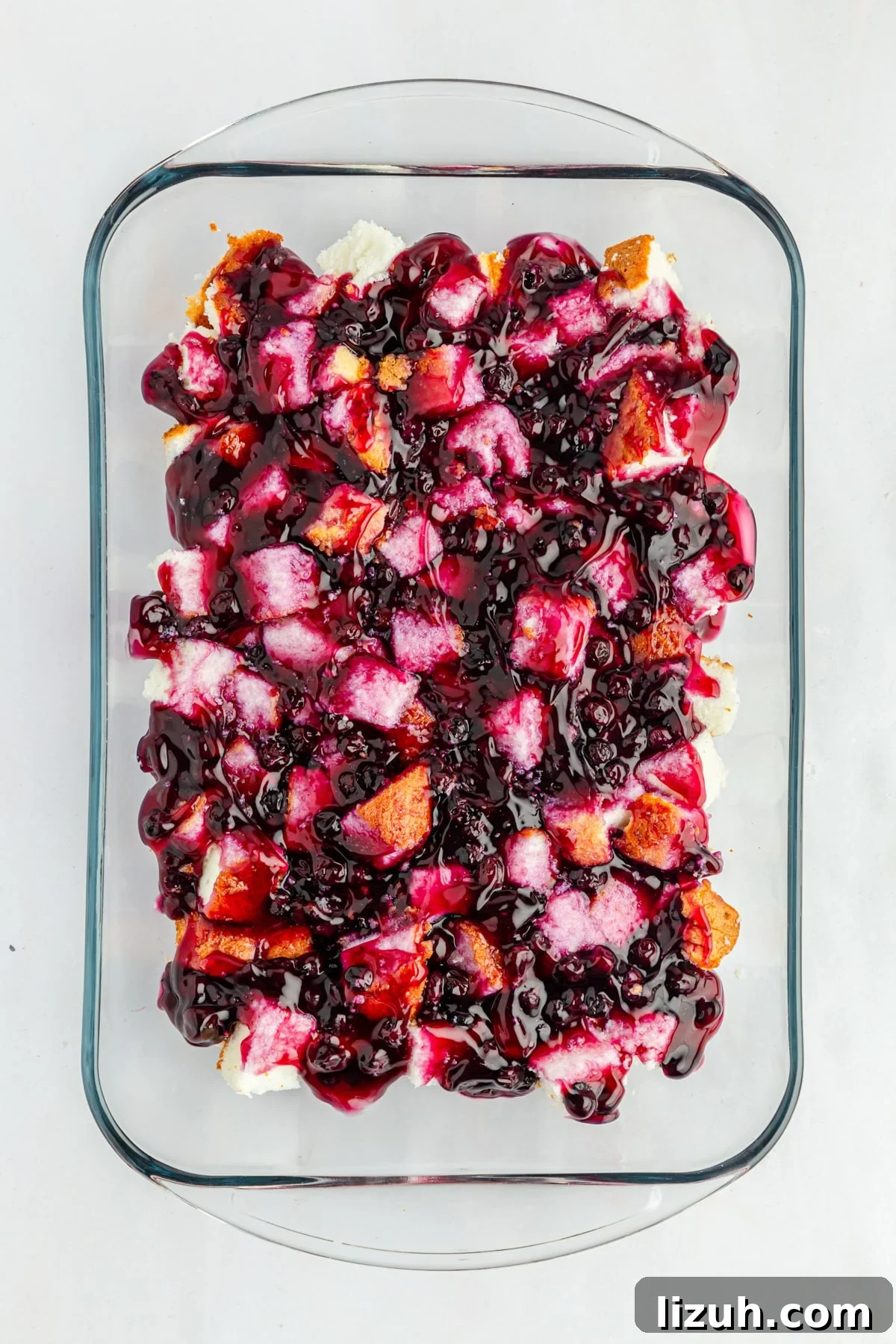No-Bake Blueberry Angel Food Cake Recipe 7 Blueberry pie filling over cake cubes in pan