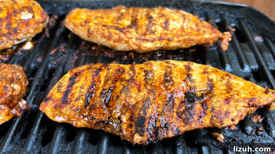 Easy Pollo Asado {Mexican Grilled or Roasted Chicken} closeup of chicken cutlet cooked on the grill