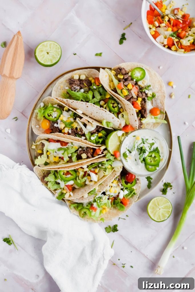 Slow-Cooked Shredded Pork Tacos with Tangy Salsa 8 Plate of Carne Asada Street Tacos with a small bowl of coconut lime crema.