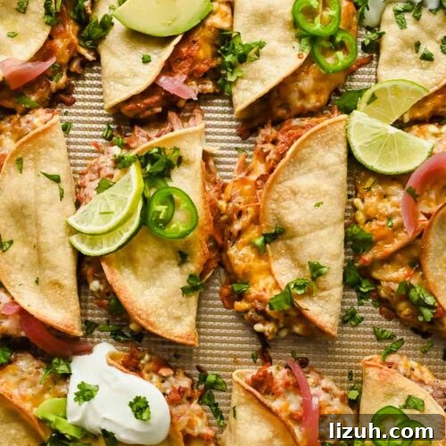 Slow-Cooked Shredded Pork Tacos with Tangy Salsa 10 baked crispy pork tacos topped with herbs, lime wedges, avocado and sour cream.