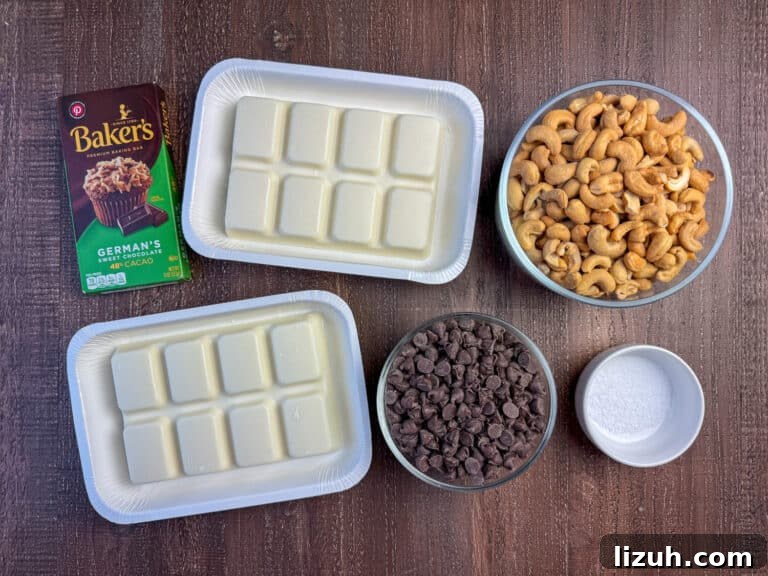 Ingredients to make chocolate covered cashews are white almond bark, whole cashews, semi sweet chocolate chips, German's sweet chocolate bar and coarse salt on a brown counter top.