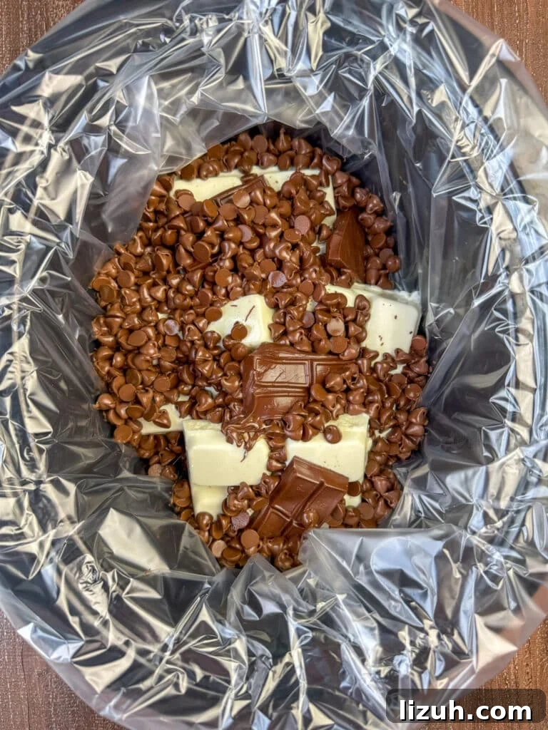 Shinny, partially melted chocolate in a slow cooker ready to stir.