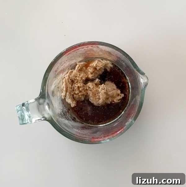 Adding the almond caramel ingredients to a glass mixing bowl.