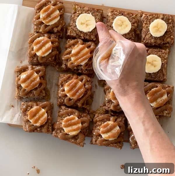 Piping the almond caramel sauce over the top of the baked Banana oatmeal squares.