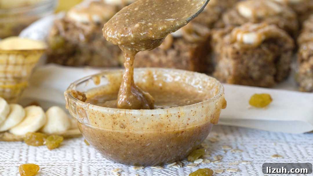 A close-up of a bowl of salted caramel sauce in a spoon.
