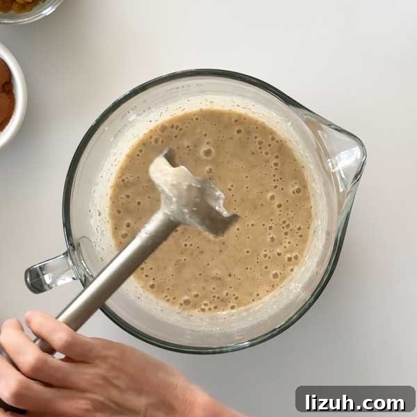 Mixing cranberries into muffin batter.