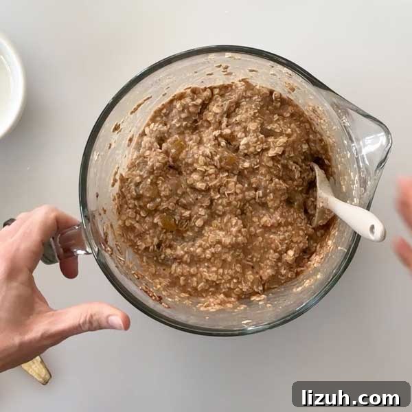 Mixing cranberries into muffin batter.