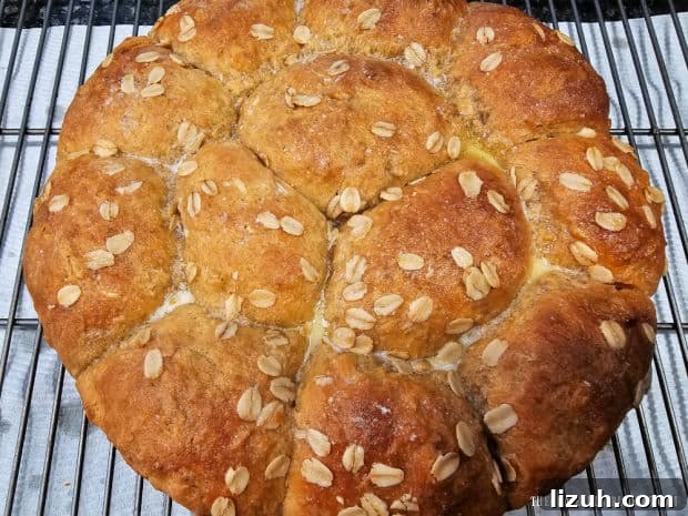 Oatmeal Molasses Dinner Rolls - The Grateful Girl Cooks! The pan of baked rolls is turned out of the pan to cool slightly on a wire rack.