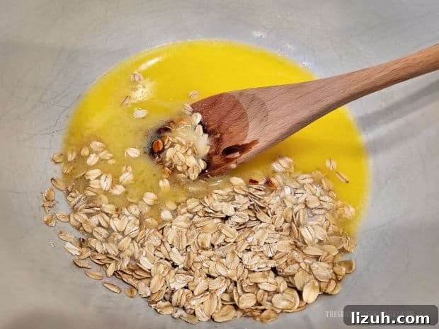 Oatmeal Molasses Dinner Rolls - The Grateful Girl Cooks! Brown sugar, oats, molasses and salt are added to the melted butter mixture in bowl.