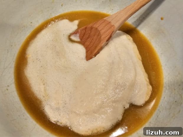 Oatmeal Molasses Dinner Rolls - The Grateful Girl Cooks! Yeast mixture is added to the melted butter mixture and stirred in until combined.