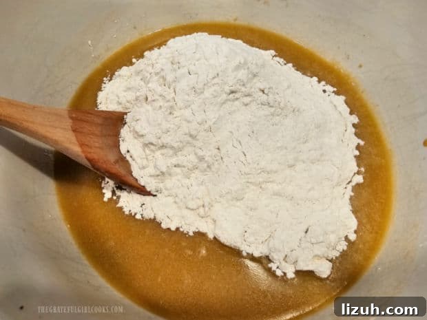 Oatmeal Molasses Dinner Rolls - The Grateful Girl Cooks! All-purpose flour is stirred into the batter for the oatmeal molasses dinner rolls.