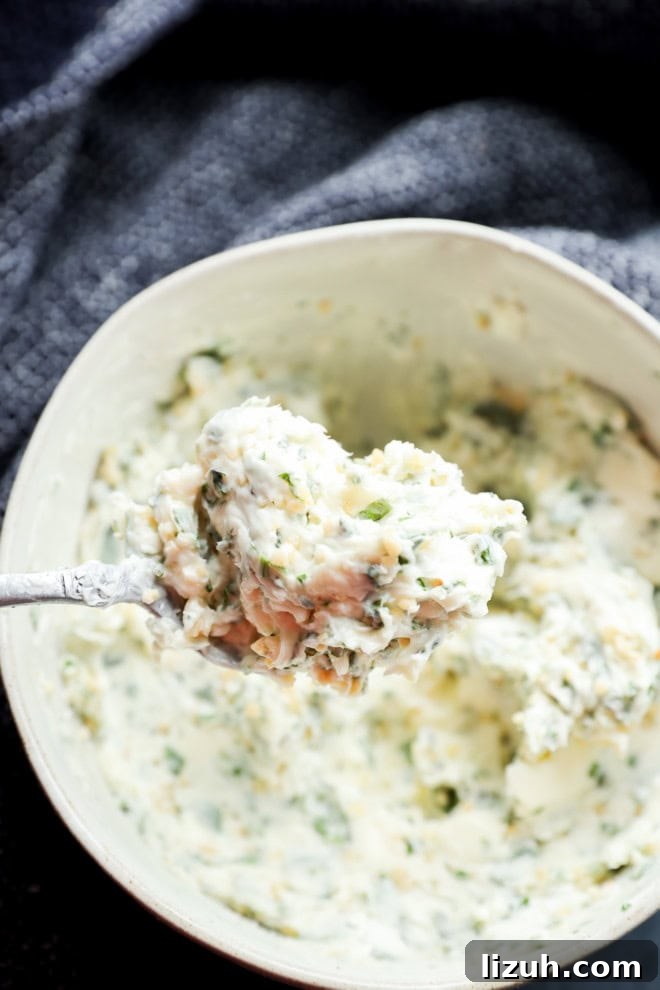 spoonful of compound butter with fresh parsley thyme and basil