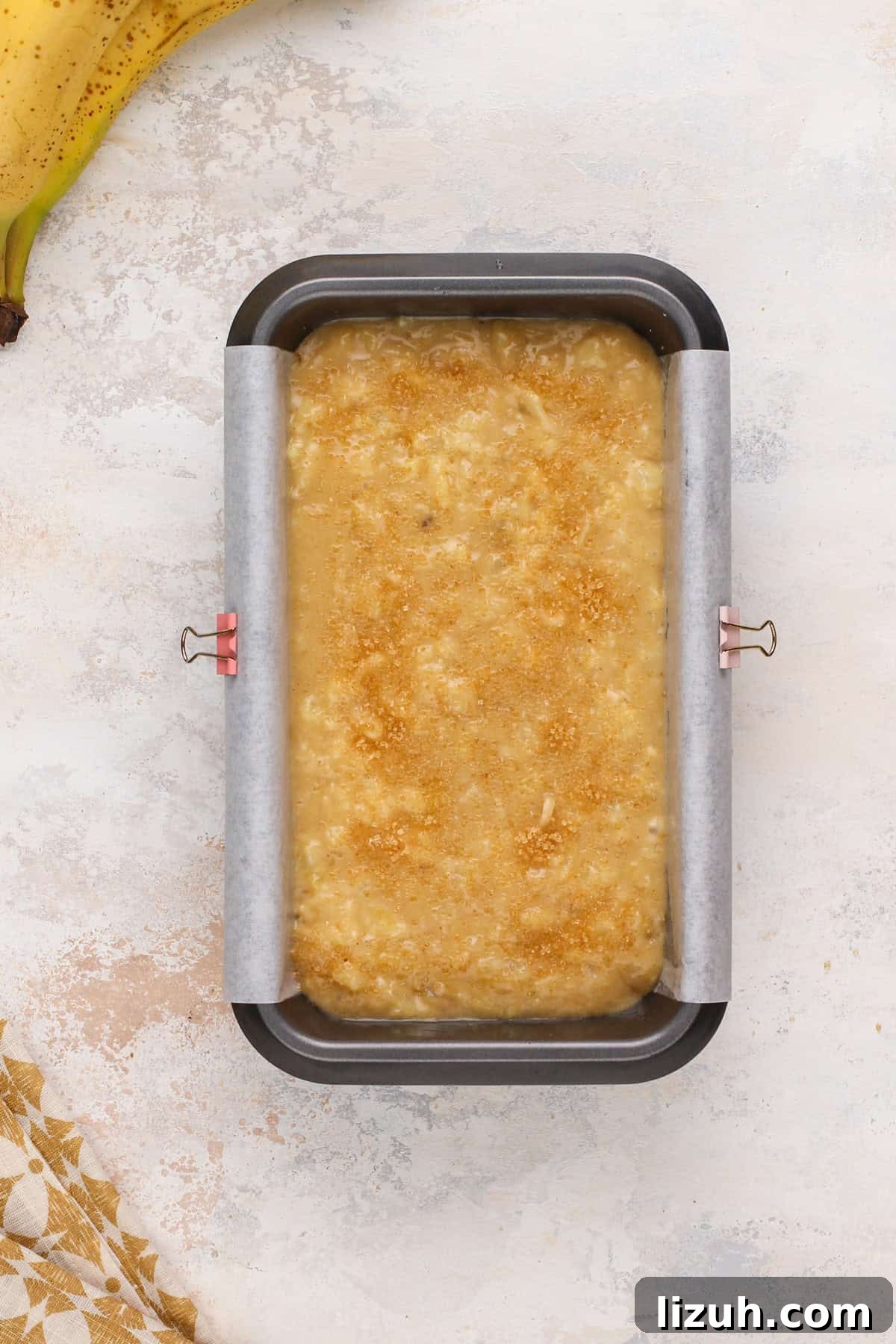 Unbaked pineapple banana bread in a loaf pan, ready to go in the oven.