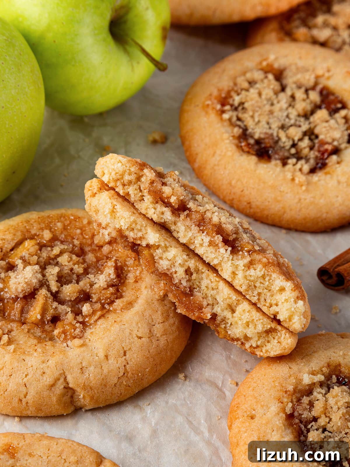 Apple Pie Cookie Recipe: Crispy Cinnamon Apple Jam Cookies 2 Cookie broken in half revealing gooey apple filling inside a chewy brown sugar dough.
