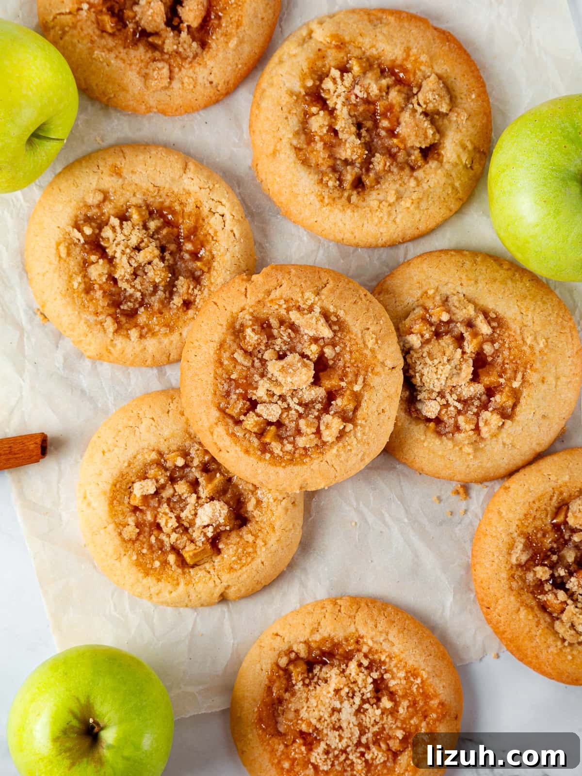 Apple Pie Cookie Recipe: Crispy Cinnamon Apple Jam Cookies 6 Assorted apple pie cookies spread on a table showing golden crumble tops and soft centers.