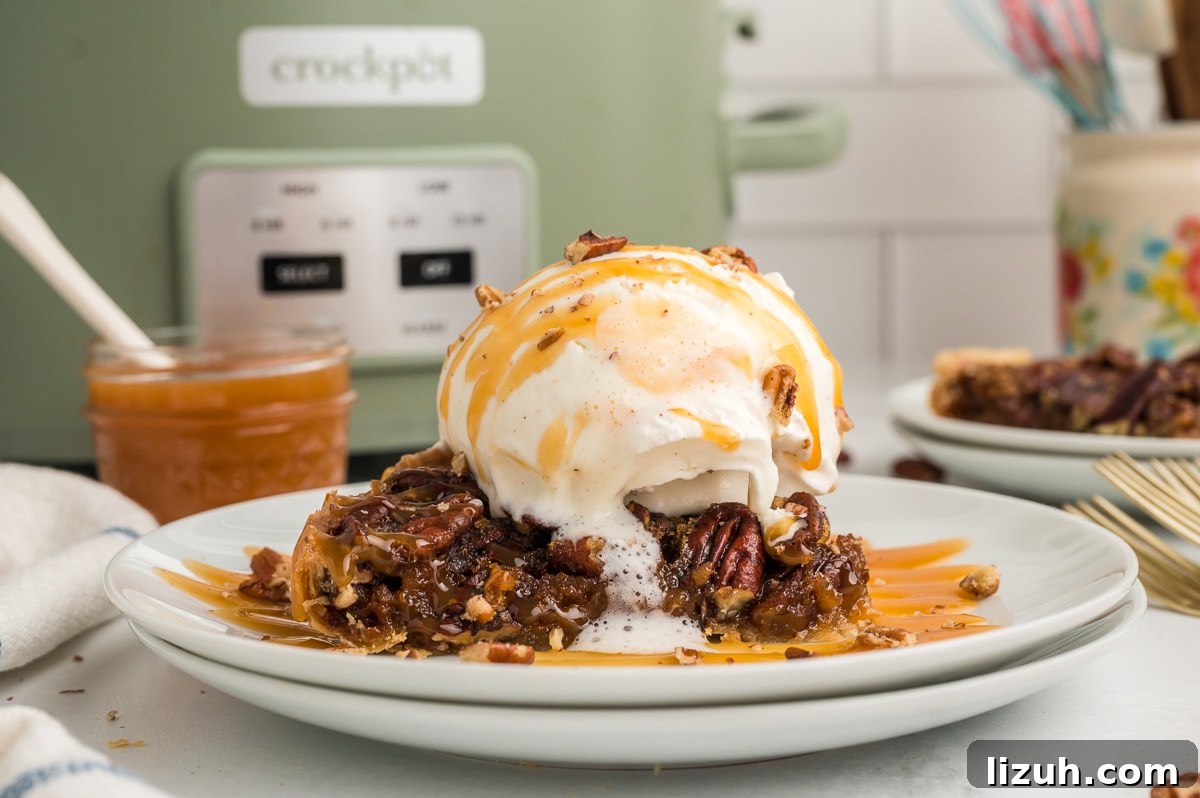 slice of pecan pie on plate with ice cream and caramel.