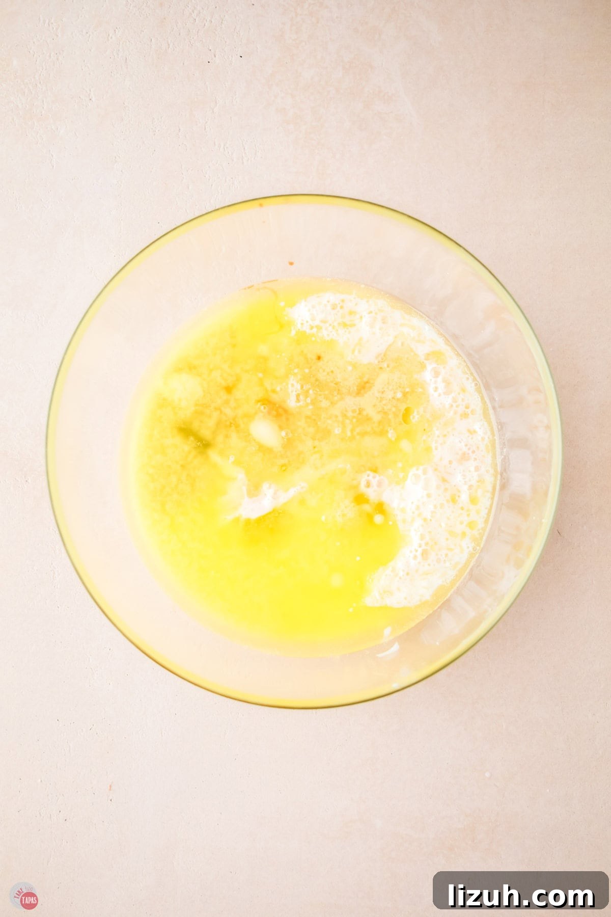 melted butter and flour to make a pancake batter in a clear bowl