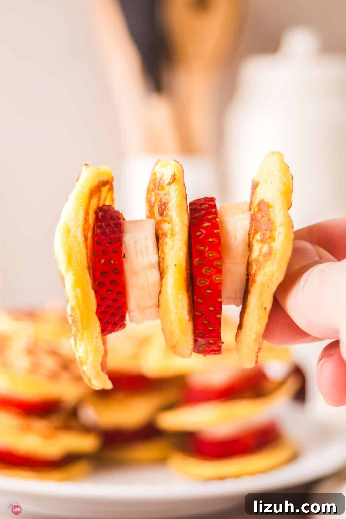 hand holding a mini pancake skewer