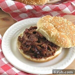 Slow Cooker Pulled Pork Tenderloin with Blackberry BBQ Sauce 9 Slow cooker pulled pork tenderloin in blackberry bbq sauce on a bun.