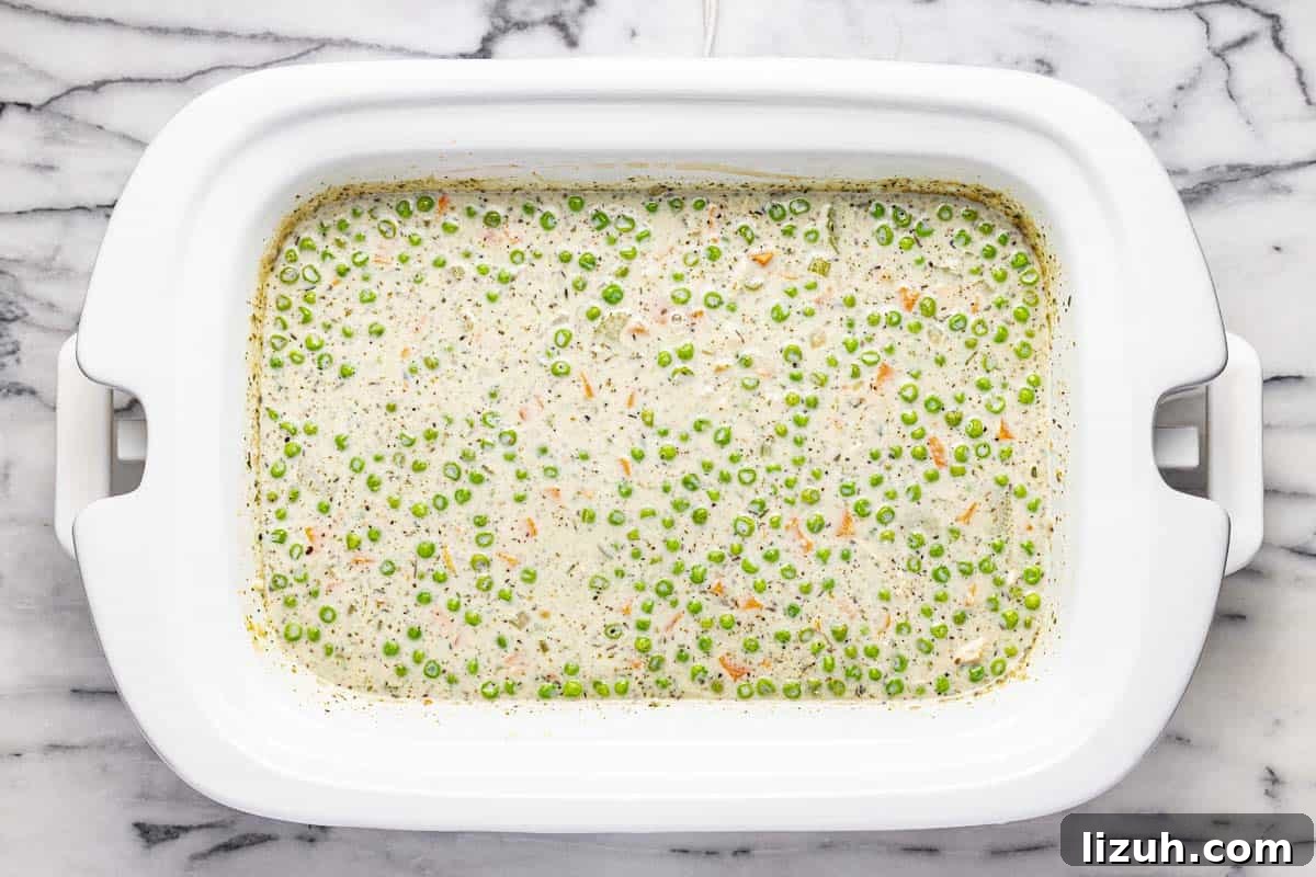 Slow Cooker Chicken and Dumplings: Comforting One-Pot Recipe 6 Slow cooker with chicken, veggies, cream, and corn starch.