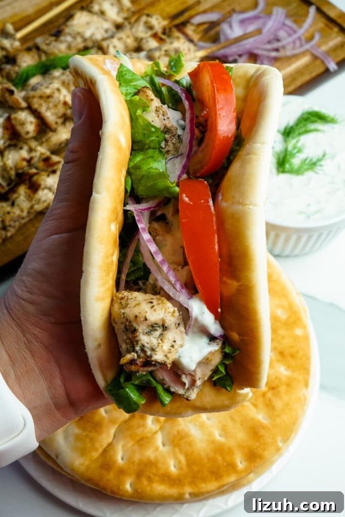 Authentic Greek Chicken Souvlaki Recipe with Tzatziki and Pita 3 Chicken souvlaki rolled up in warm pita bread to make a chicken gyro.