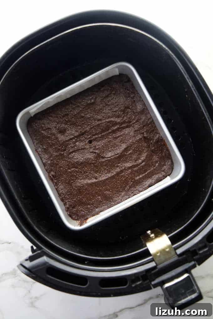Chewy Air Fryer Brownies: Quick Fudgy Chocolate Recipe 3 A pan of brownies in an air fryer basket.